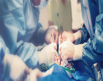 Medical team of surgeons in hospital doing minimal invasive surgical interventions.