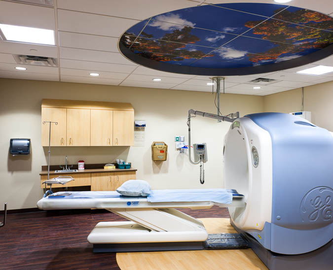 Picture of a CT Scan room with equipment that is used for assisting patients during  the process. CT imaging combines special x-ray equipment with sophisticated computers to produce multiple images or pictures of the inside of the body. These cross-sectional images of the area being studied can then be examined on a computer monitor locally or remotely