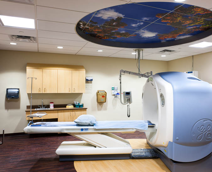 Picture of a CT Scan room with equipment that is used for assisting patients during the process. CT imaging combines special x-ray equipment with sophisticated computers to produce multiple images or pictures of the inside of the body. These cross-sectional images of the area being studied can then be examined on a computer monitor locally or remotely