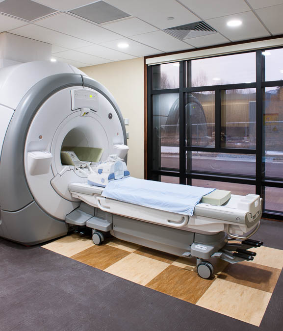 This is a picture of a CT machine for MRI&apos;s
During an MRI, your body goes into the center of the magnet. The magnet makes the hydrogen atoms in your body line up in one direction.  While the magnet switches on/off, on/off, radio waves go through your body, bounce off your lined-up atoms, and hit the radio &quot;antenna&quot; in the coil around your body.  The computer takes those radio signals from the coil and translates them into a 3-D picture!