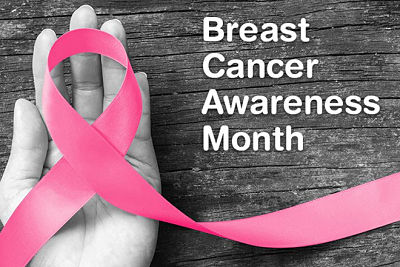 Picture of a woman's hand holding a pink ribbon
Banner says:
Breast Cancer Awareness Month