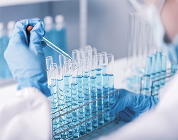 chemist,scientist hand dropping chemical liquid into test tube