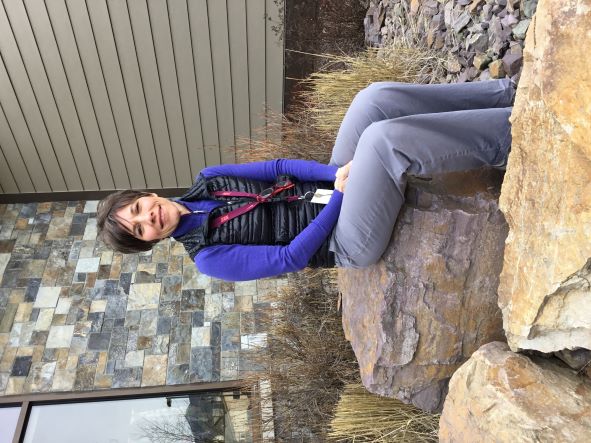 Picture of Nicole Kapa (Registered Dietician) sitting outside of CPMC on a rock, smiling.